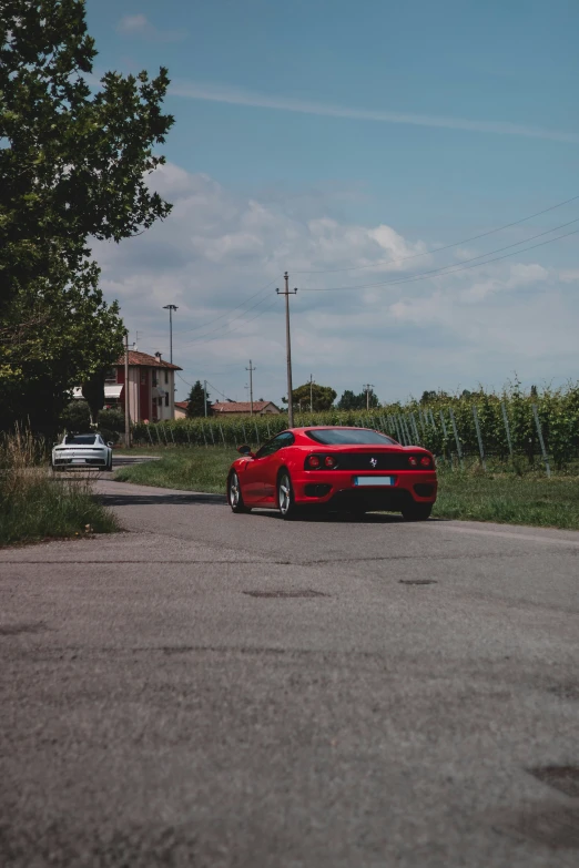 a red car sits on the side of the road