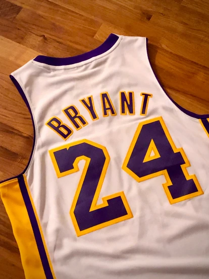 a basketball jersey with the number 24 on it sitting on the floor