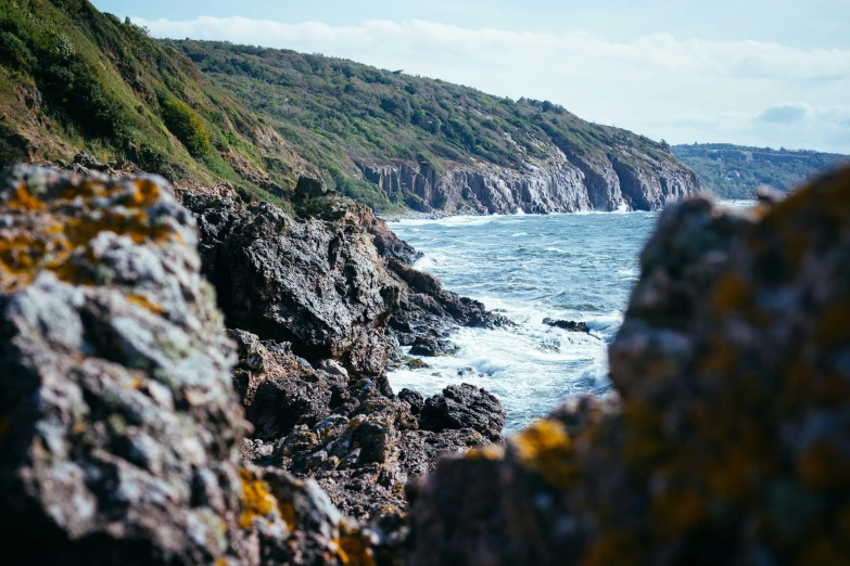 a large body of water sitting next to a cliff