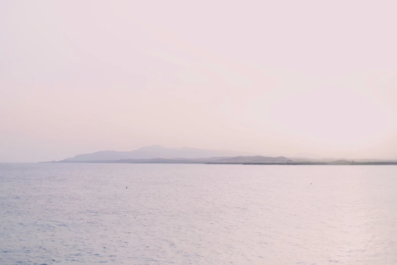 two people sitting on a small boat in the middle of the ocean