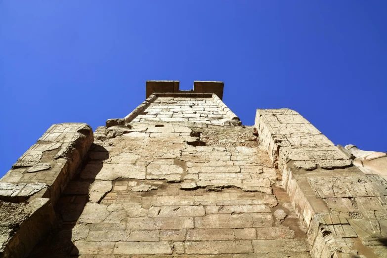 a very tall brick structure with a sky in the background