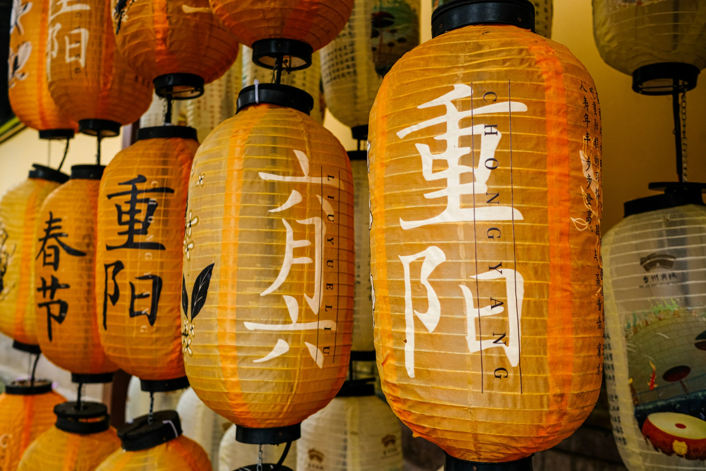 many small lanterns with asian writing on them