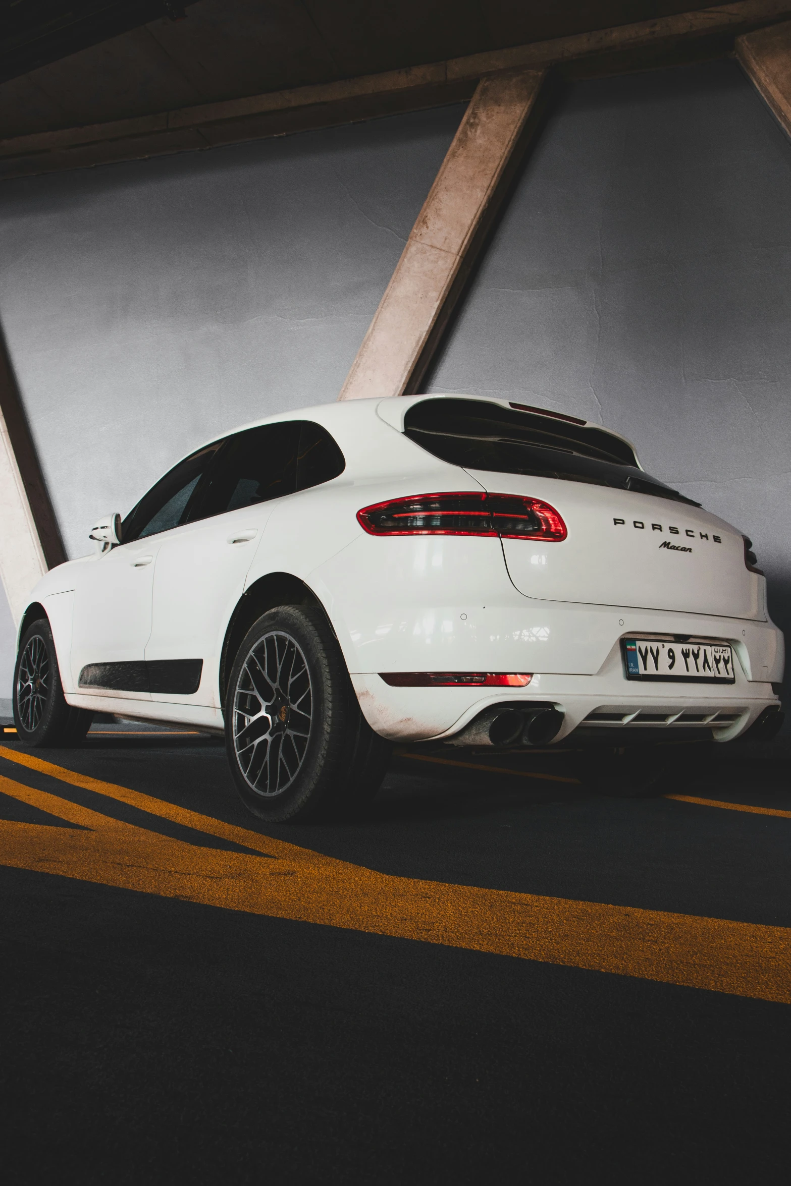 the rear view of a porsche cayenne parked in an underground parking space