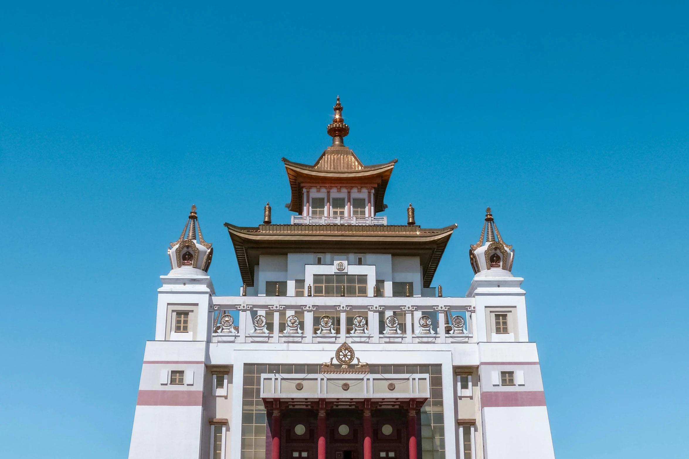 white building in asian style with a roof, doorway and windows