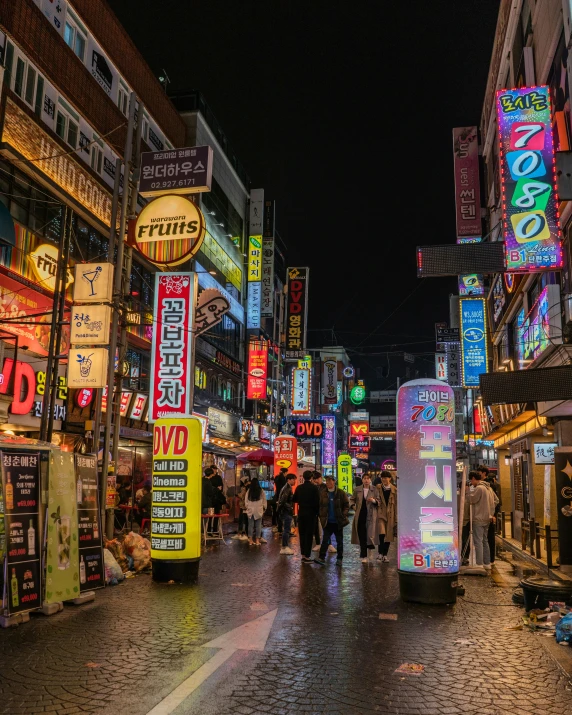 a busy asian market with lots of neon signs