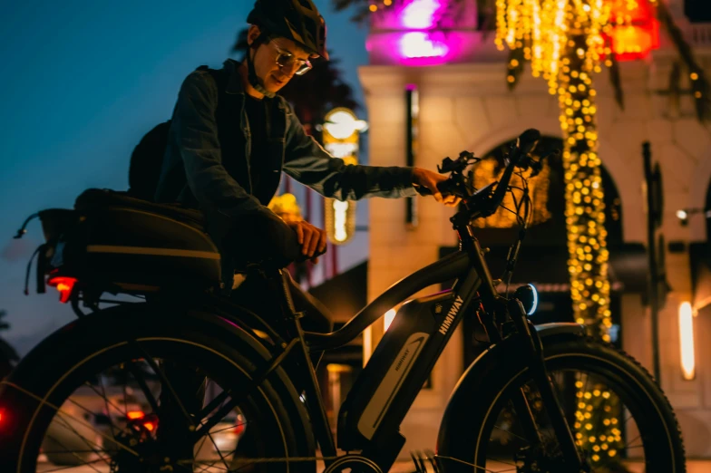 a man that is sitting on a bicycle in the street