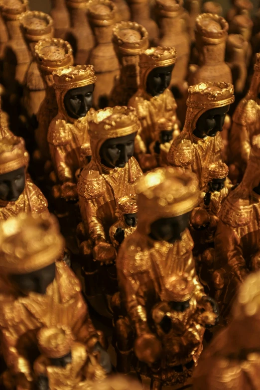 a group of gold statues and some brown objects