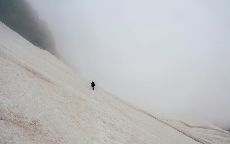 a person climbing up a snow covered mountain