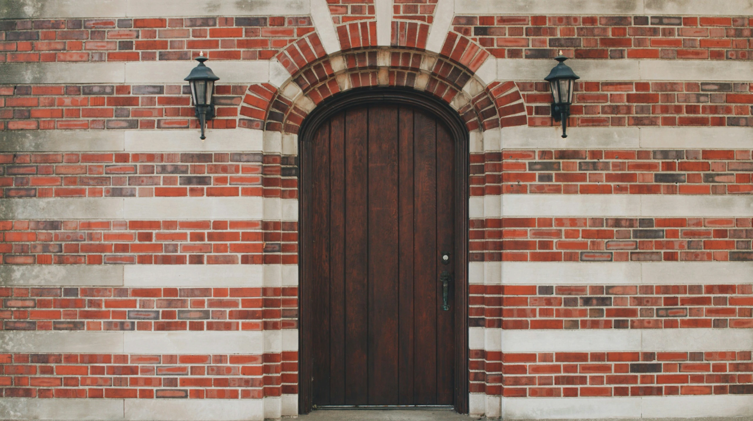 a building with a large wooden door and two lanterns