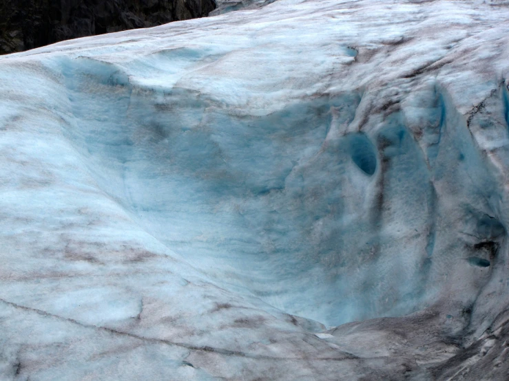 a man is climbing down an ice cliff