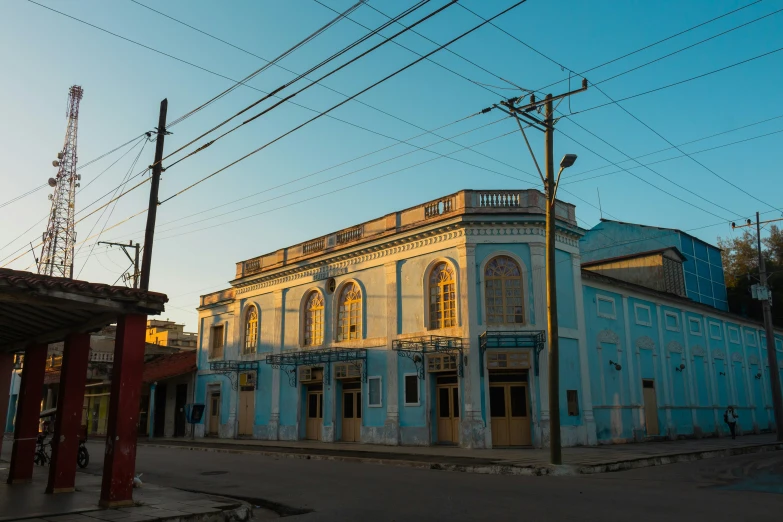 an old building sitting on the side of a road