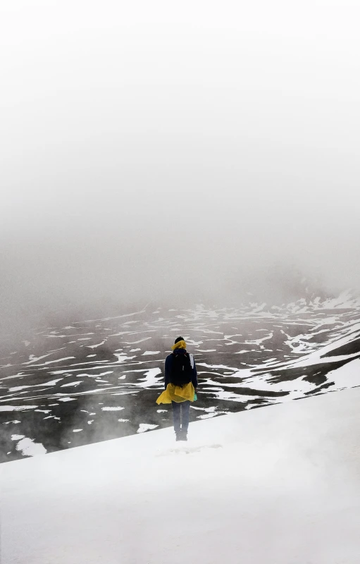 a man standing in snow looking at the distance