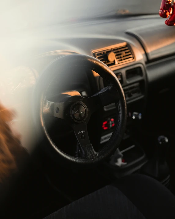 the dashboard of a vintage car, with a clock and sun glares through the lens