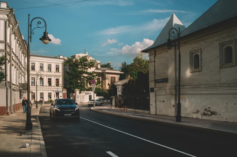 a car traveling down a quiet road near a city