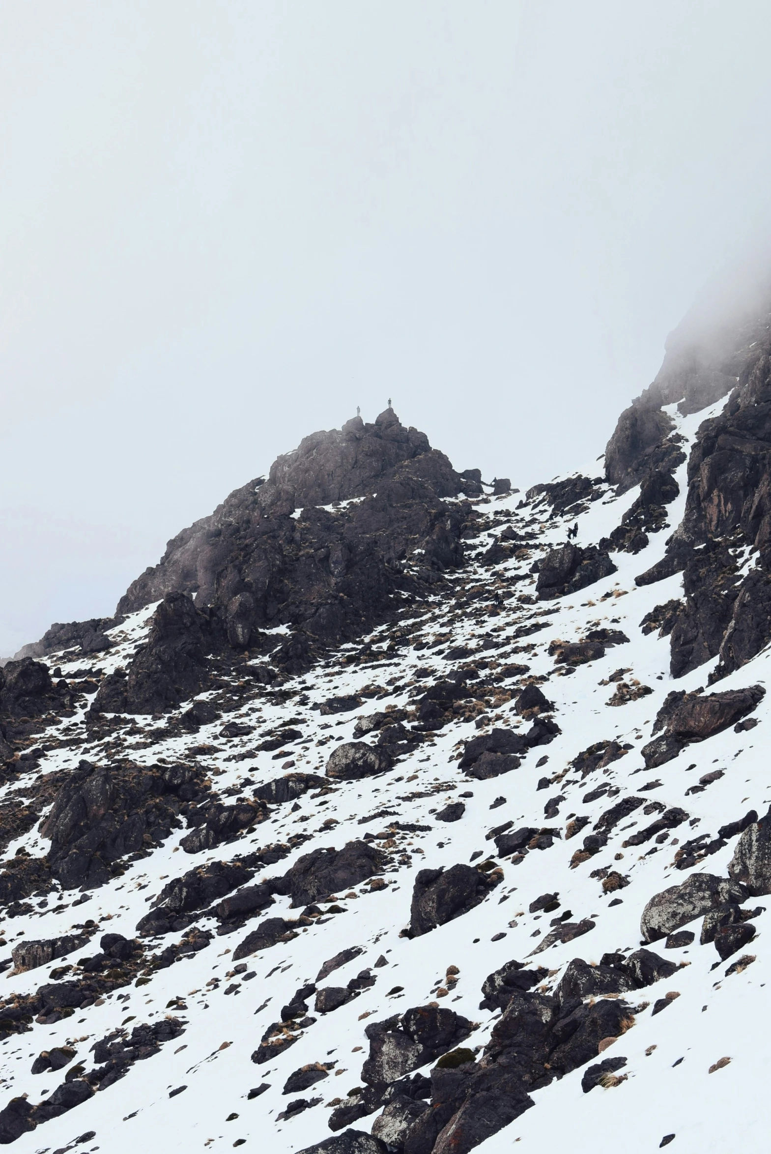 the skier is going up the snowy mountain