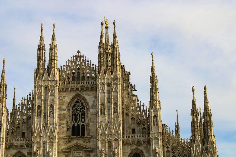 a close up of the face and roof of an old cathedral