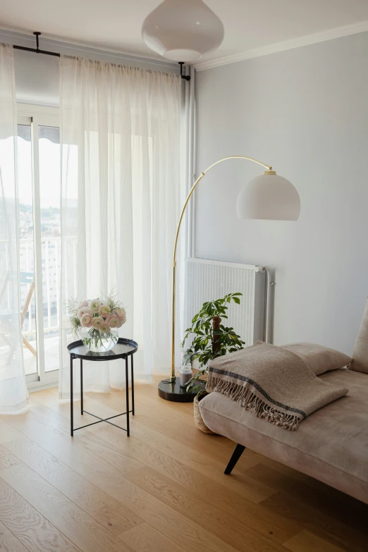 a white bedroom with white curtains and a white sofa