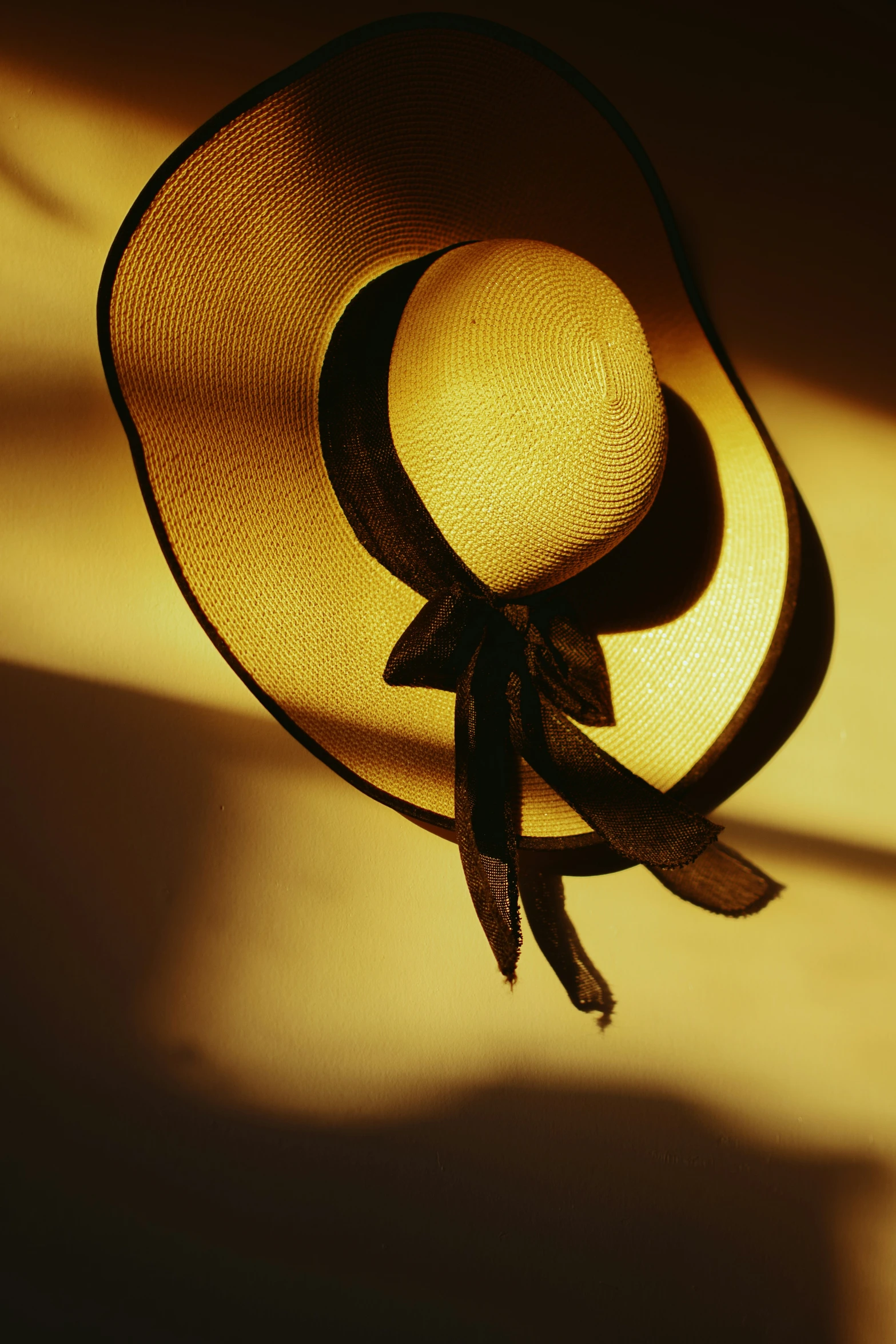 a close up view of the top of a straw hat with a black bow on it