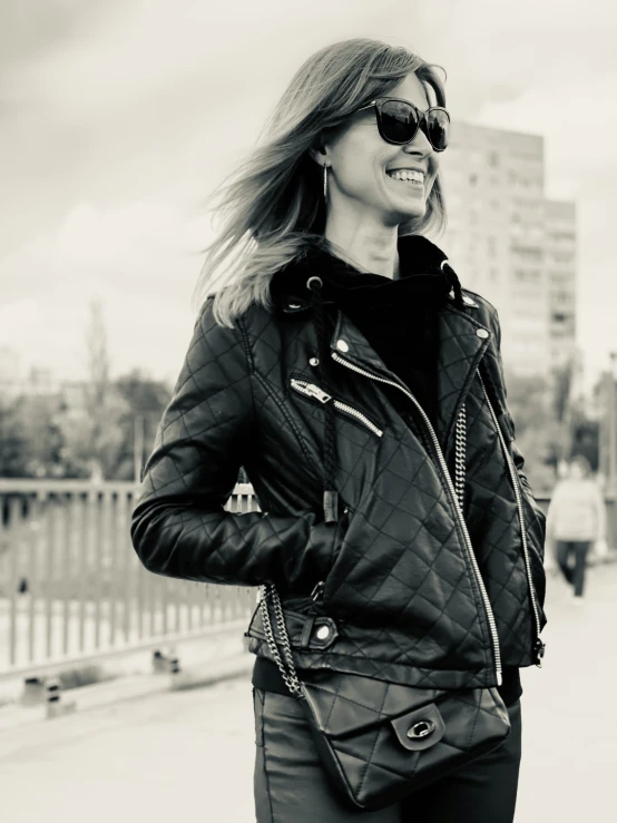 a woman in black leather pants and a jacket