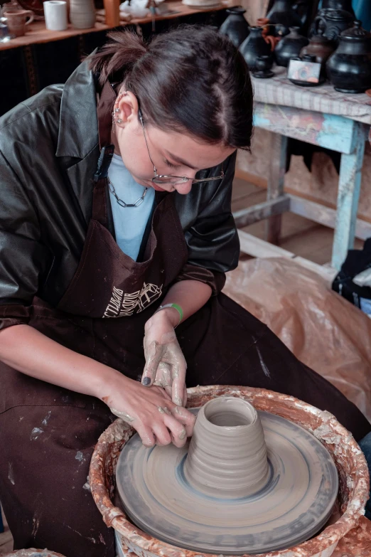 a person making a vase with their hands