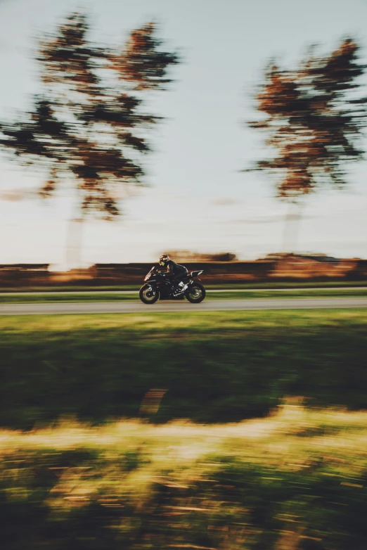 a man rides a motorcycle through the woods