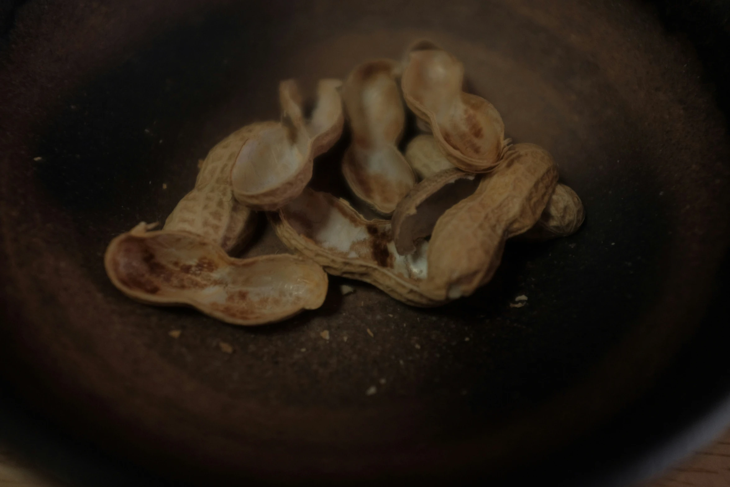 a black bowl filled with nuts sitting on top of a table