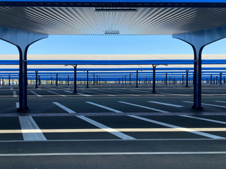 empty parking lot with ocean in background and open awnings