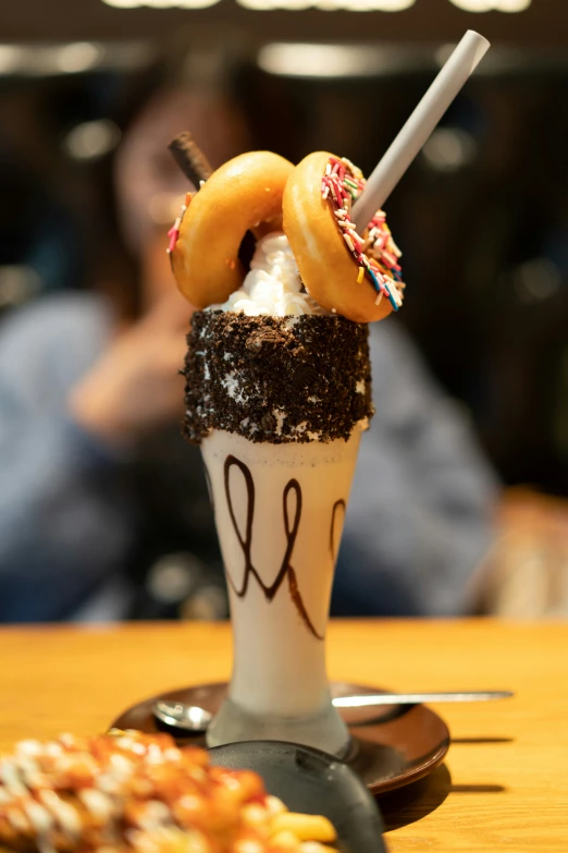 cup filled with chocolate doughnut and sprinkles on top