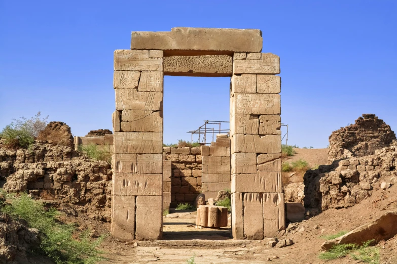 there is an arch and doorway in the wall