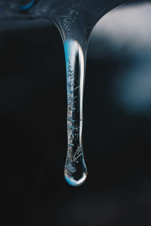 a drop of water on top of a faucet