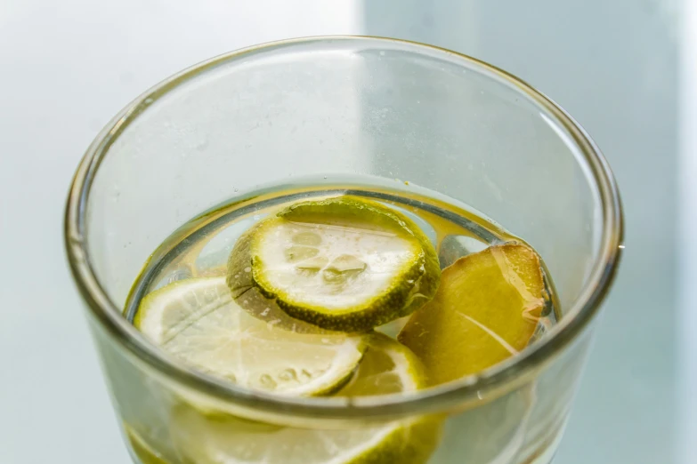 some lemons and lime wedges sitting in a glass