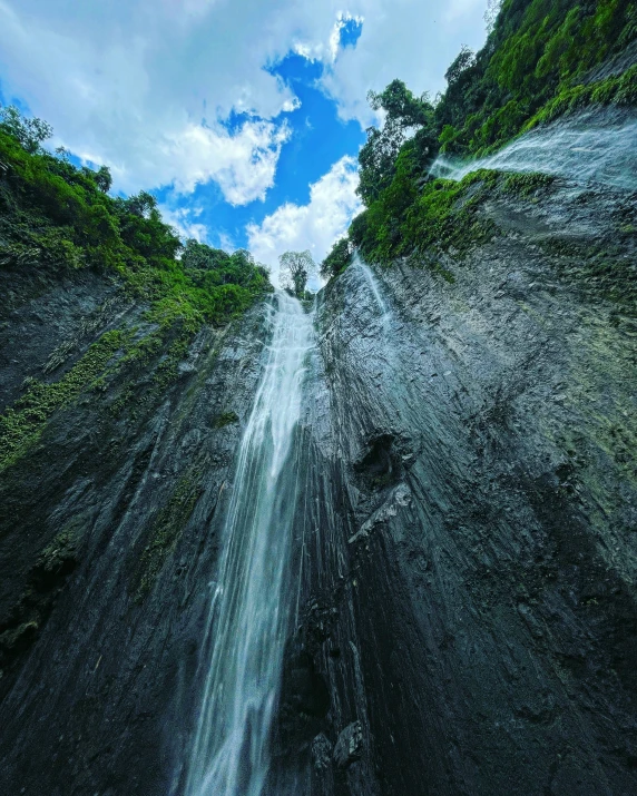 a waterfall is seen from above as it flows down a mountain