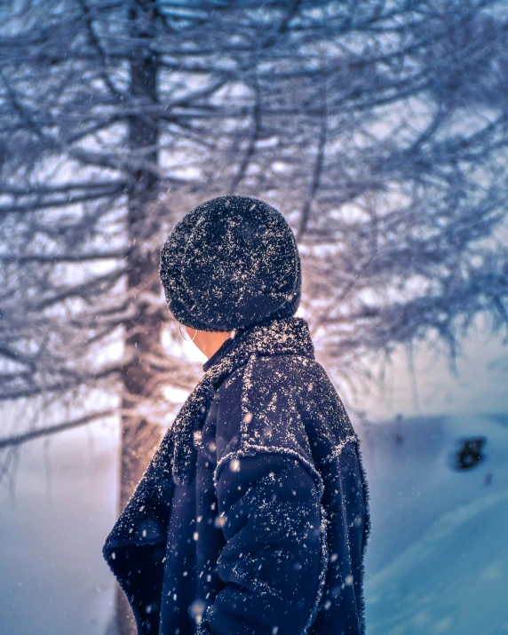 someone in the snow wearing a winter hat