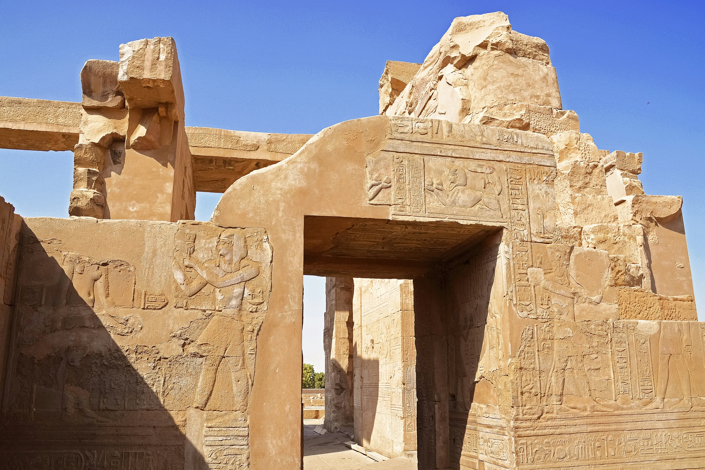 the entrance to a building with many large statues