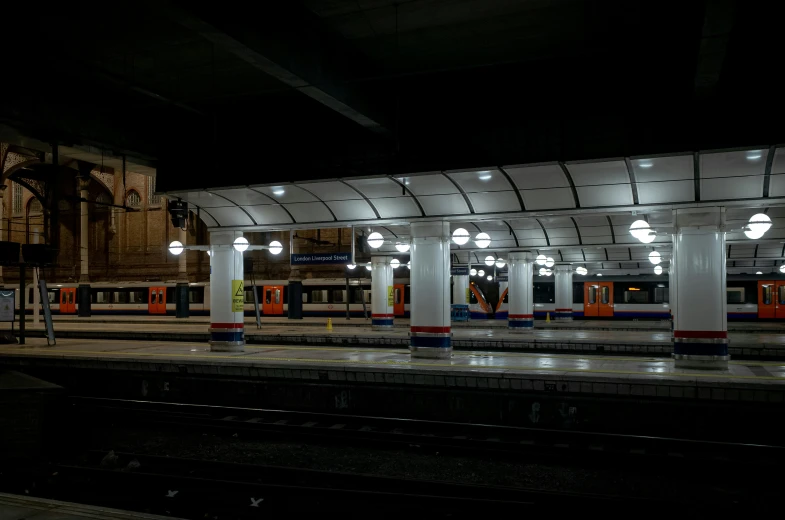 a train station with several lights that shine on the top of it