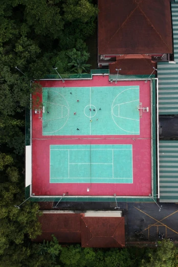 an aerial view of a school gymnasium with green pitch markings