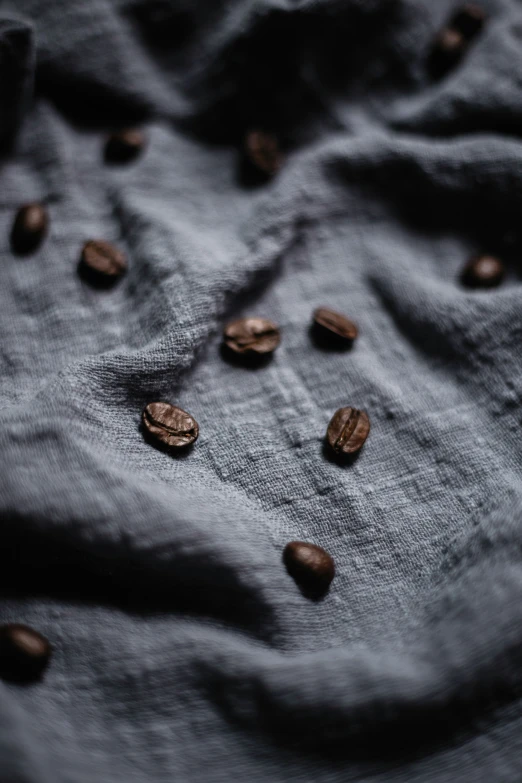 some almonds sitting on a cloth with some water droplets