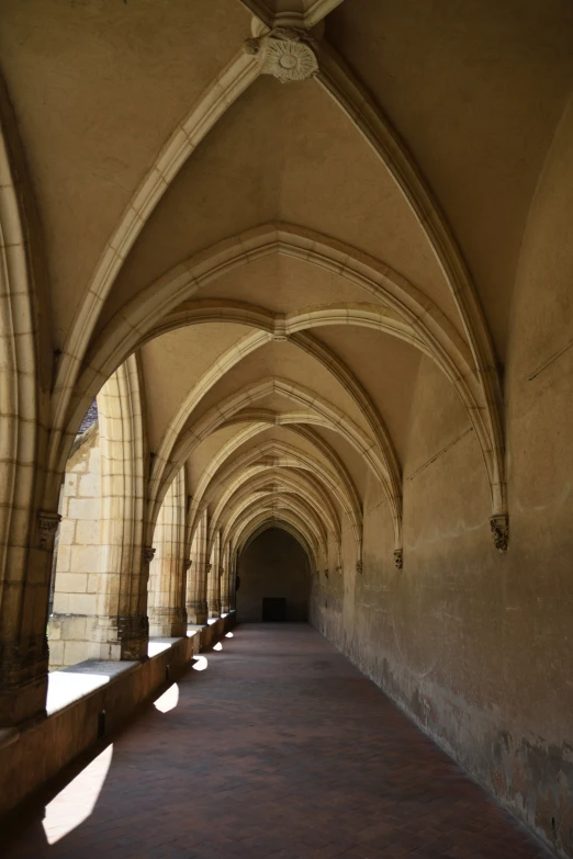 a very long hallway lined with brick arches