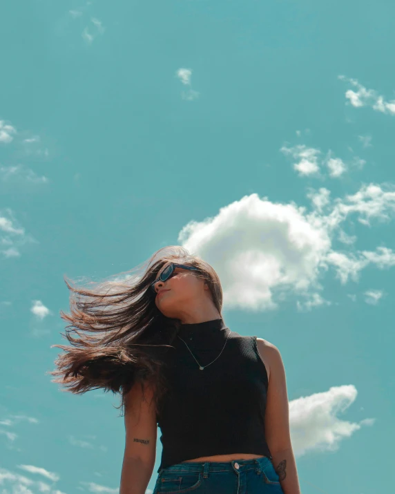 woman with long, straight hair with her head in the air