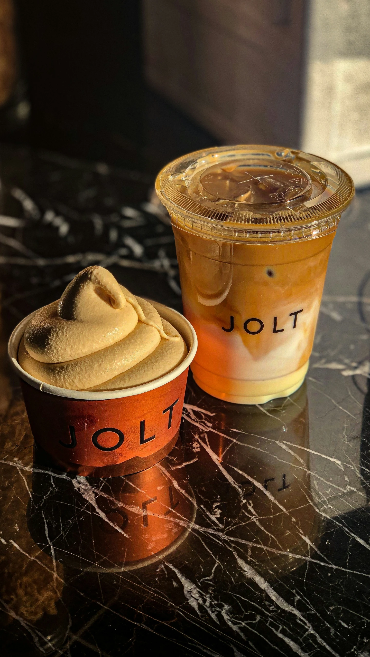 two dessert cups with a desert topping sitting on the counter