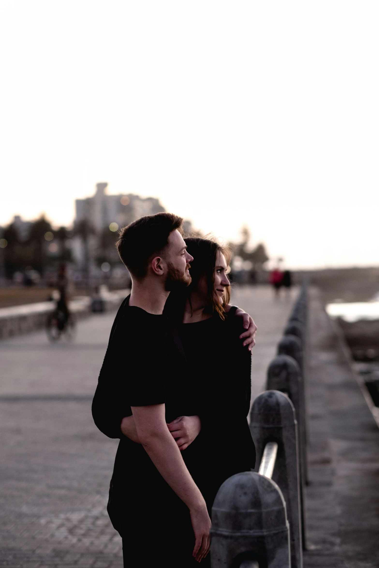 a man and woman are posing for a po near the water