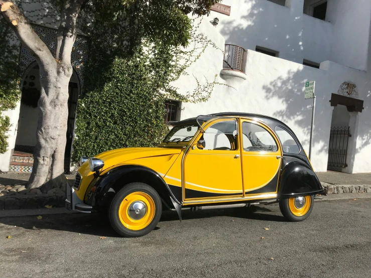 a classic automobile that looks like it is painted yellow
