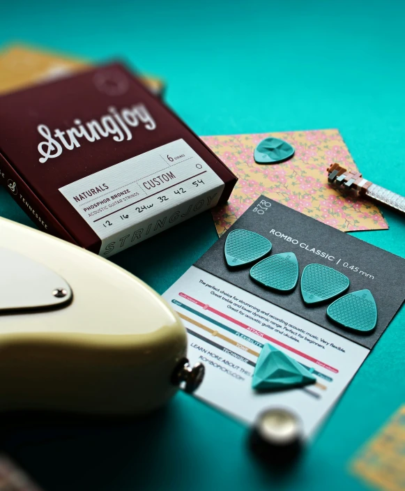 green leaves, a pair of scissors, and several paper clips on a table