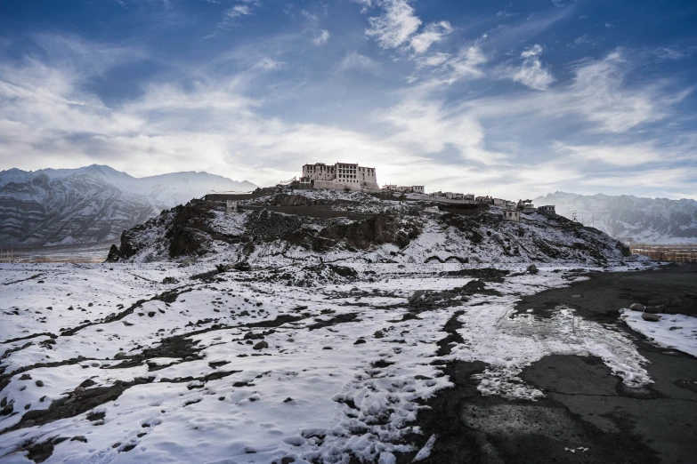 a snow covered hill with a castle on top