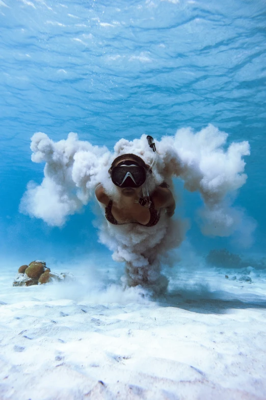 scuba diver with bubbles in the ocean and in background