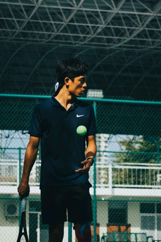 a young man with a tennis racket gets ready to hit a ball