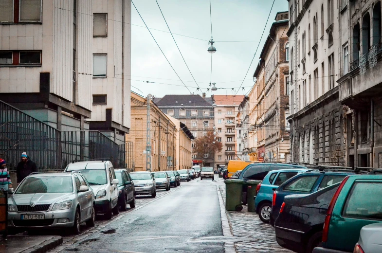 some cars parked in an alleyway between two buildings