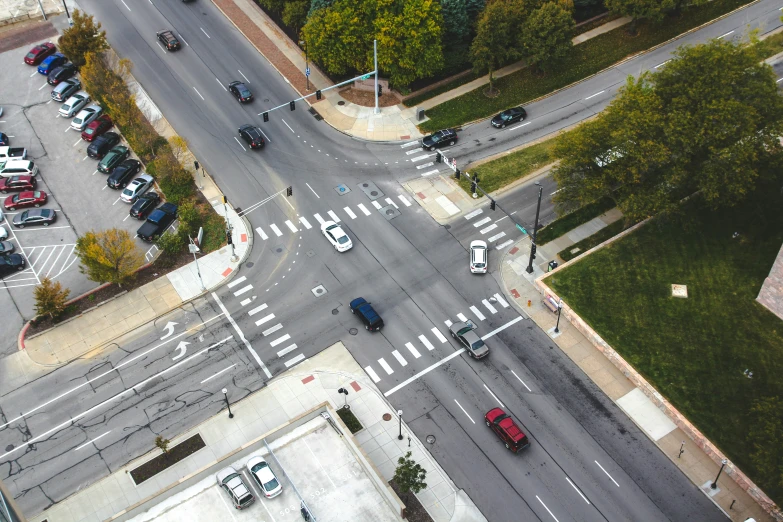 a busy intersection with several cars parked next to it