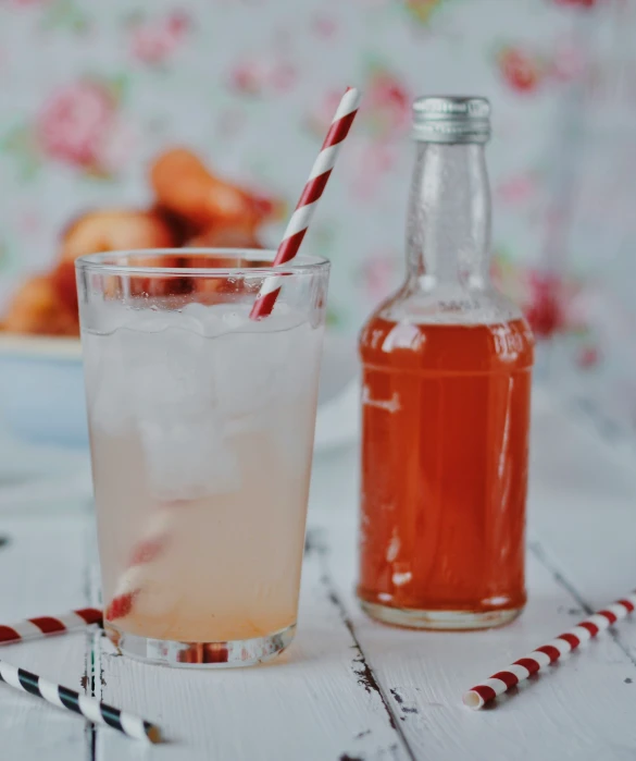 a bottle and a glass of beverage on a table