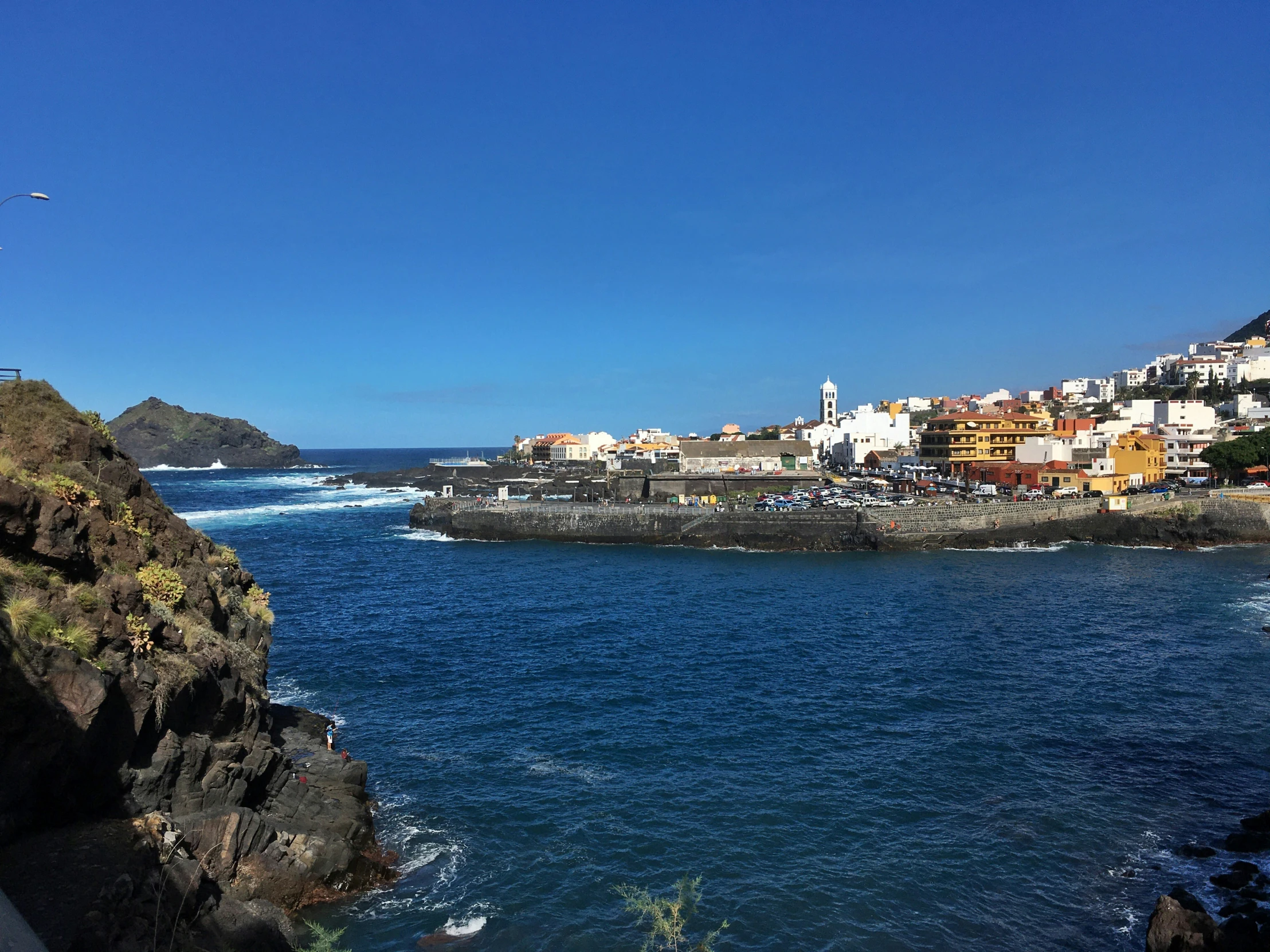 a beach and some buildings and blue water